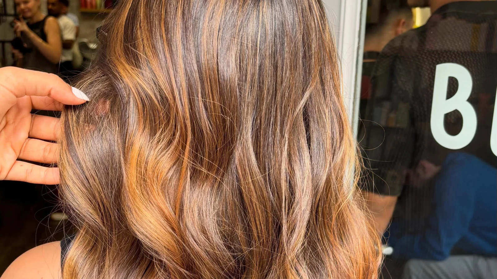 Warm caramel balayage hair colour on wavy brunette hair at Blend Beauty Artisans, Capel Street Dublin